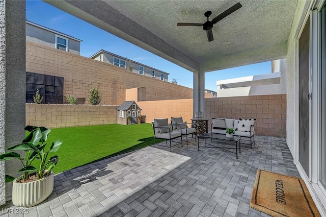 view of patio / terrace featuring ceiling fan, a fenced backyard, and outdoor lounge area