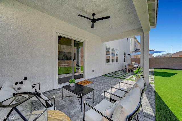 view of patio featuring ceiling fan, outdoor dining space, outdoor lounge area, and fence