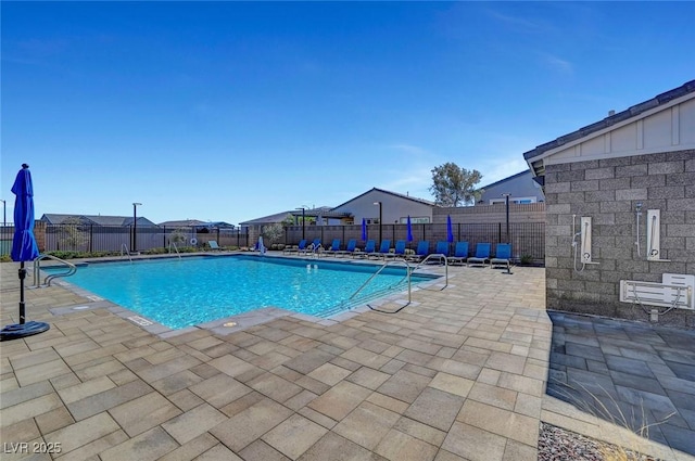 pool with fence and a patio