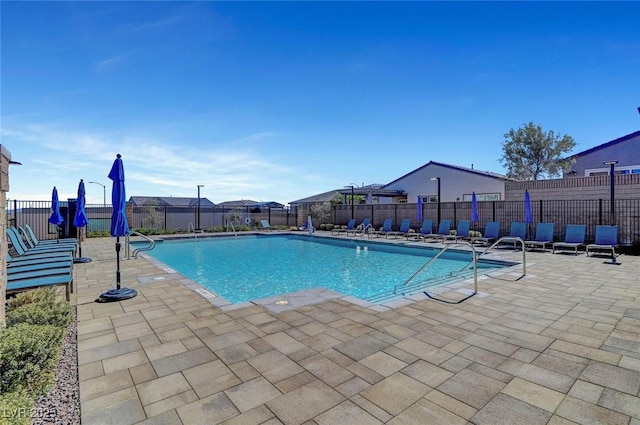 pool featuring fence and a patio