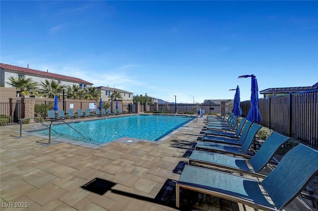 pool with fence and a patio