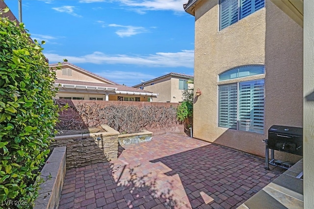 view of patio / terrace featuring fence