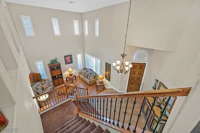 stairs featuring a chandelier and a healthy amount of sunlight