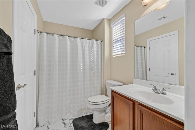 bathroom with toilet, vanity, and visible vents