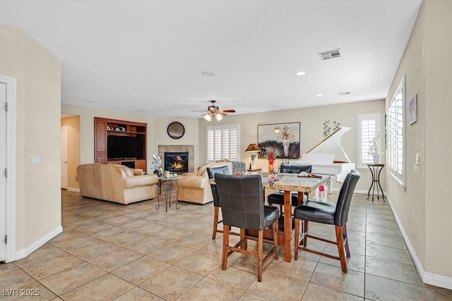 dining area with ceiling fan, recessed lighting, a fireplace, visible vents, and baseboards