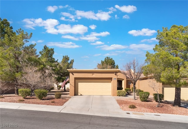 view of front of home with driveway, an attached garage, and stucco siding