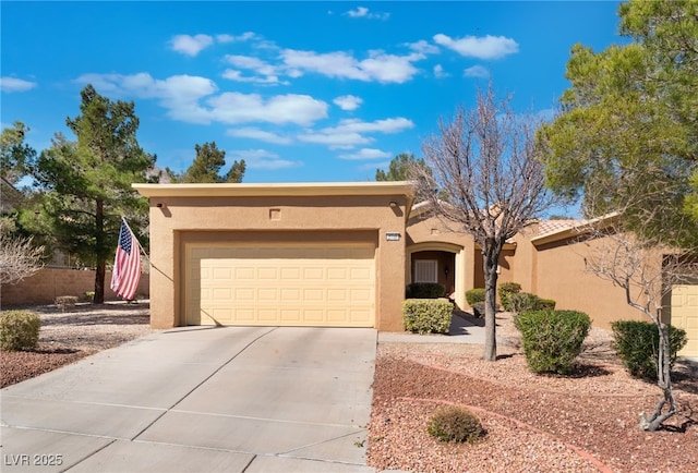 southwest-style home with a garage, driveway, and stucco siding