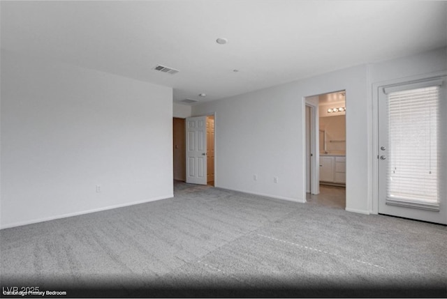 unfurnished room with carpet flooring, visible vents, and baseboards