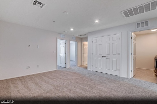 empty room with light colored carpet and visible vents