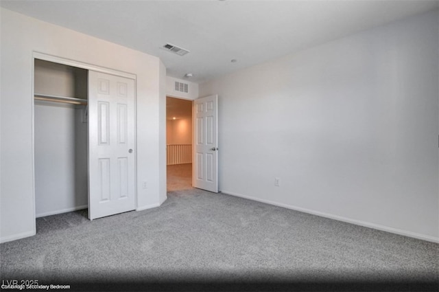 unfurnished bedroom featuring carpet, a closet, visible vents, and baseboards