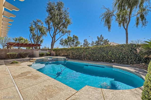 view of swimming pool with a patio area, a pool with connected hot tub, and a fenced backyard