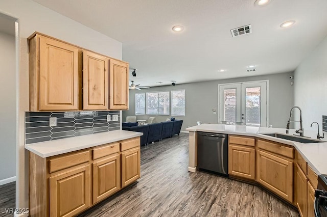 kitchen with visible vents, open floor plan, a sink, wood finished floors, and dishwasher