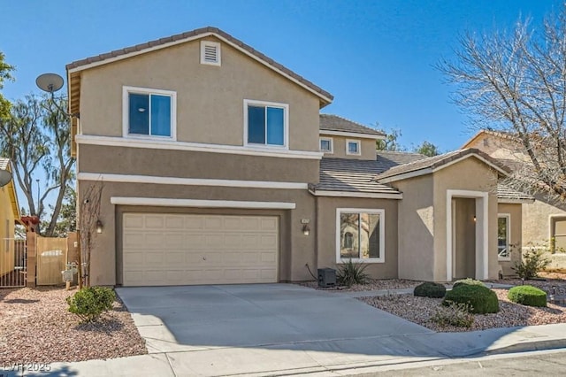 traditional home with a tile roof, stucco siding, concrete driveway, an attached garage, and fence