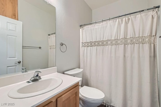 full bath featuring vanity and toilet