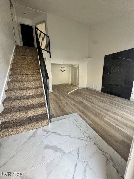 stairway with baseboards and wood finished floors