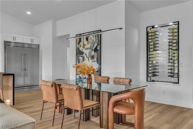 dining room with baseboards and light wood finished floors