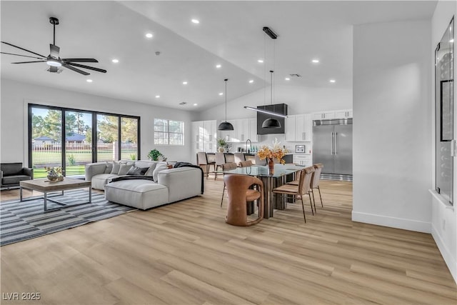 living room featuring recessed lighting, baseboards, light wood finished floors, and high vaulted ceiling