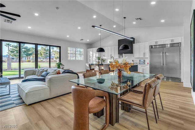 dining area featuring visible vents, recessed lighting, high vaulted ceiling, and light wood-style floors