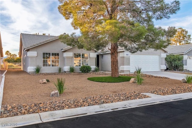 single story home with stucco siding, concrete driveway, an attached garage, and a tiled roof