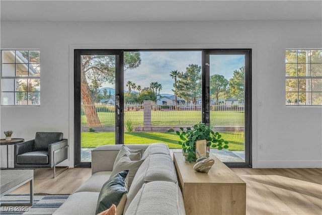 living room with light wood-style flooring and baseboards