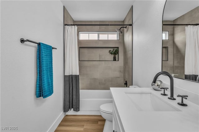 bathroom with vanity, toilet, wood finished floors, and shower / tub combo with curtain