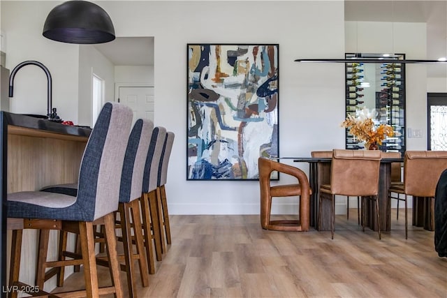 dining room with baseboards and wood finished floors