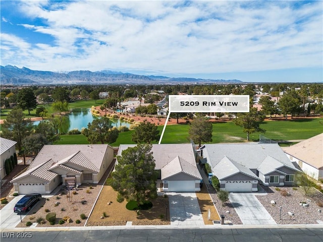 birds eye view of property with a water and mountain view