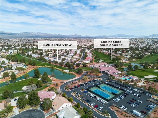 birds eye view of property featuring golf course view and a water and mountain view