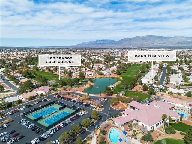 birds eye view of property with a water and mountain view