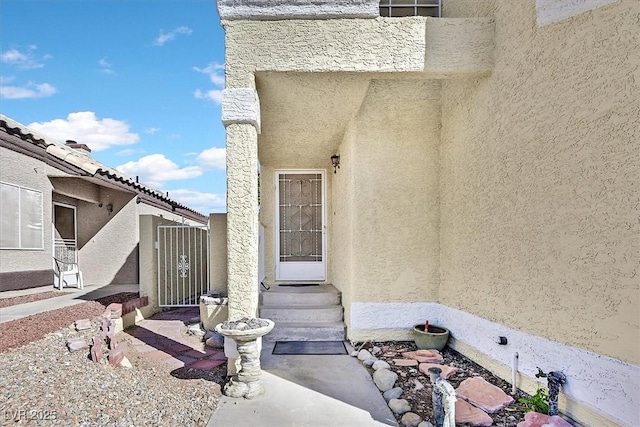 property entrance with stucco siding