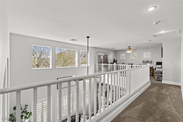 hall with carpet floors, baseboards, visible vents, and recessed lighting