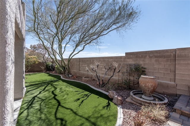 view of yard with a fenced backyard