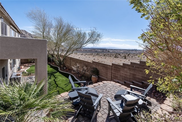 view of patio / terrace featuring fence