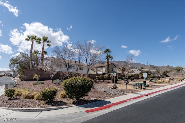 view of front of house with fence and a mountain view