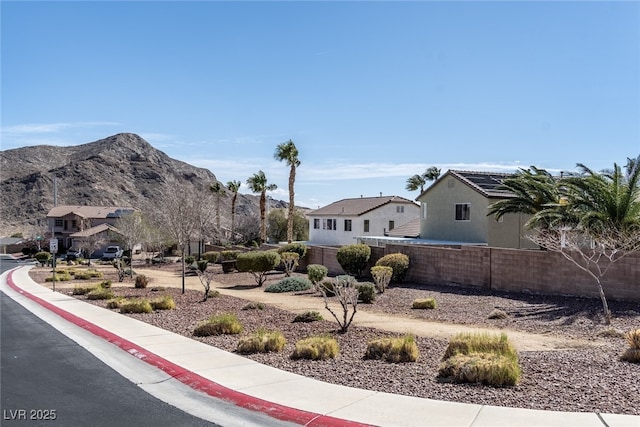 exterior space featuring fence and a mountain view