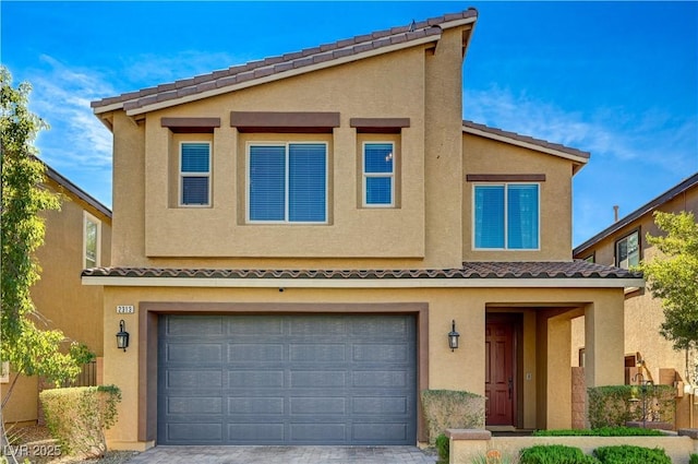 multi unit property featuring driveway, an attached garage, a tile roof, and stucco siding