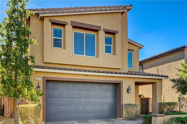 view of front of house featuring driveway, a tiled roof, an attached garage, and stucco siding