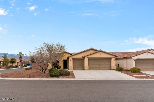 mediterranean / spanish-style home with a tiled roof, a garage, driveway, and stucco siding