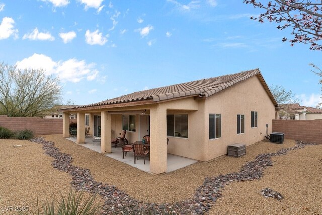 back of property featuring a fenced backyard, stucco siding, a tile roof, and a patio