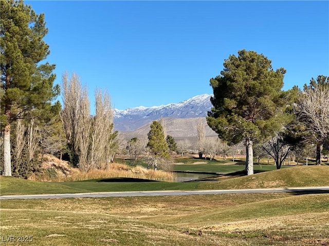 view of home's community featuring a lawn and a water and mountain view