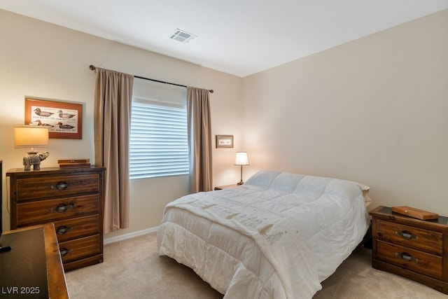 bedroom with visible vents, baseboards, and light colored carpet