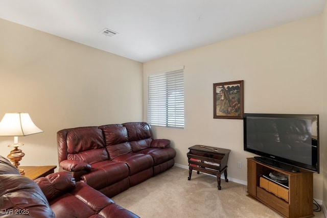 living area featuring light colored carpet, visible vents, and baseboards