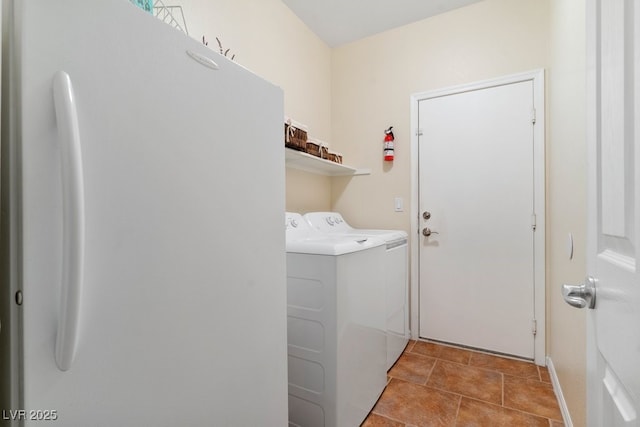 laundry area with washer and clothes dryer, laundry area, and tile patterned flooring