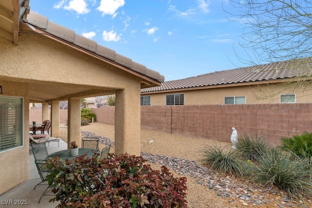 view of patio with outdoor dining area and a fenced backyard