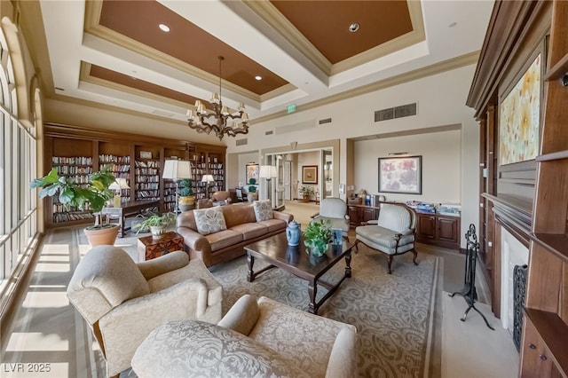 living room with a chandelier, ornamental molding, a towering ceiling, and visible vents