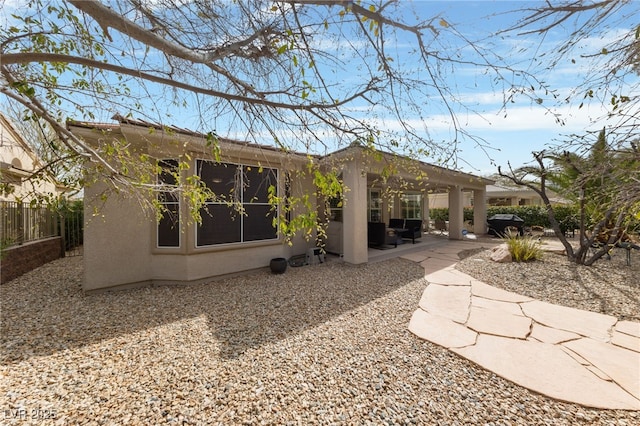 back of property with a patio area, fence, and stucco siding