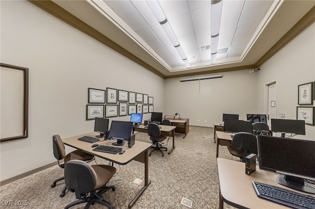 office featuring carpet, visible vents, a raised ceiling, and baseboards