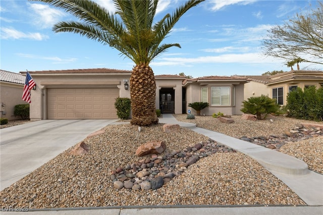 view of front of home with a garage, driveway, and stucco siding