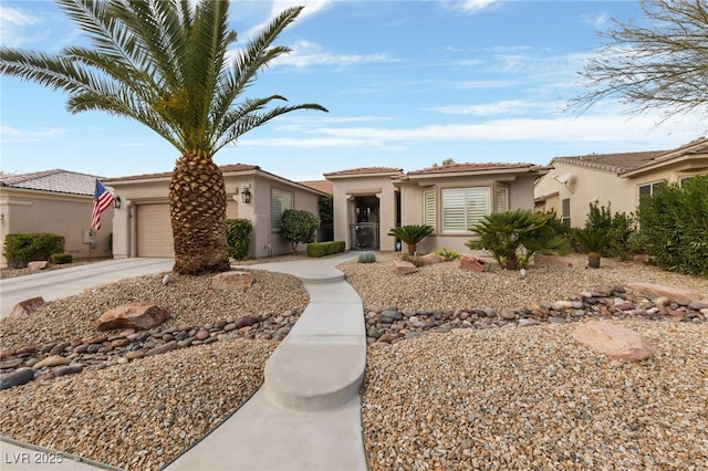 view of front of home with a garage, concrete driveway, and stucco siding