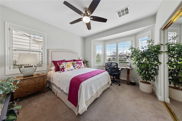 carpeted bedroom with ceiling fan, visible vents, and baseboards